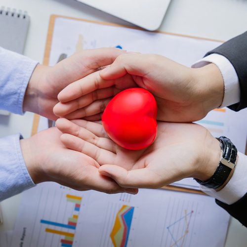 two businessman holding red heart.Heart of success.Concepts of success