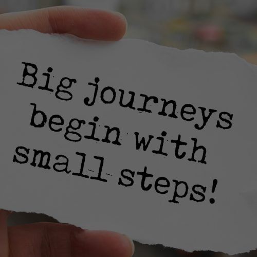 Big journeys begin with small steps. Words written under torn pa